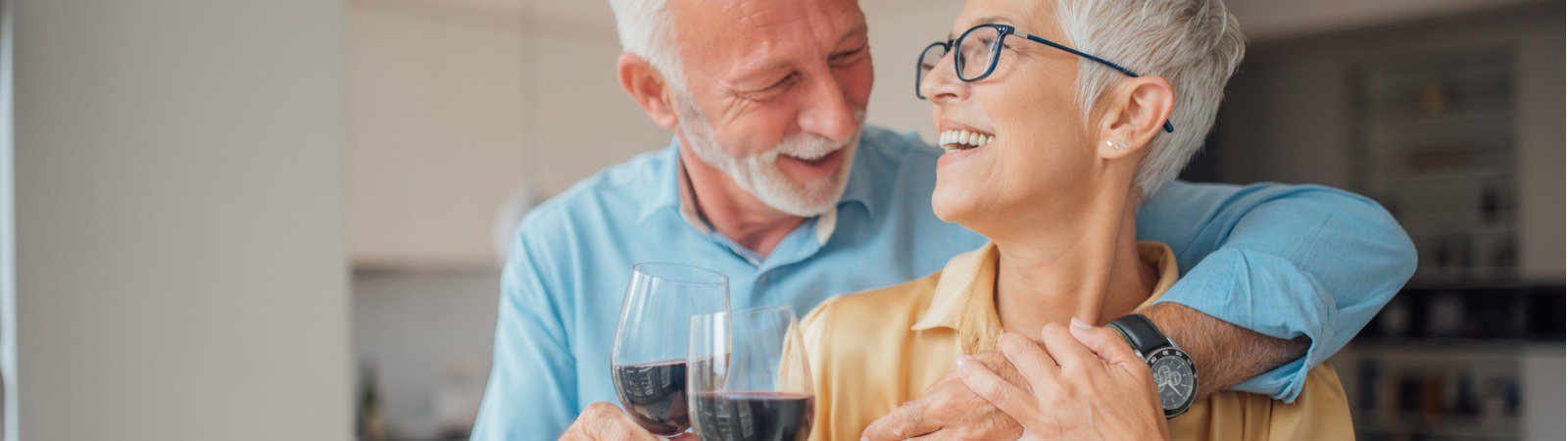 smiling-man-and-woman-holding-glasses-of-red-wine