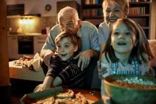 Grandparents with Grandkids enjoying their movie night.