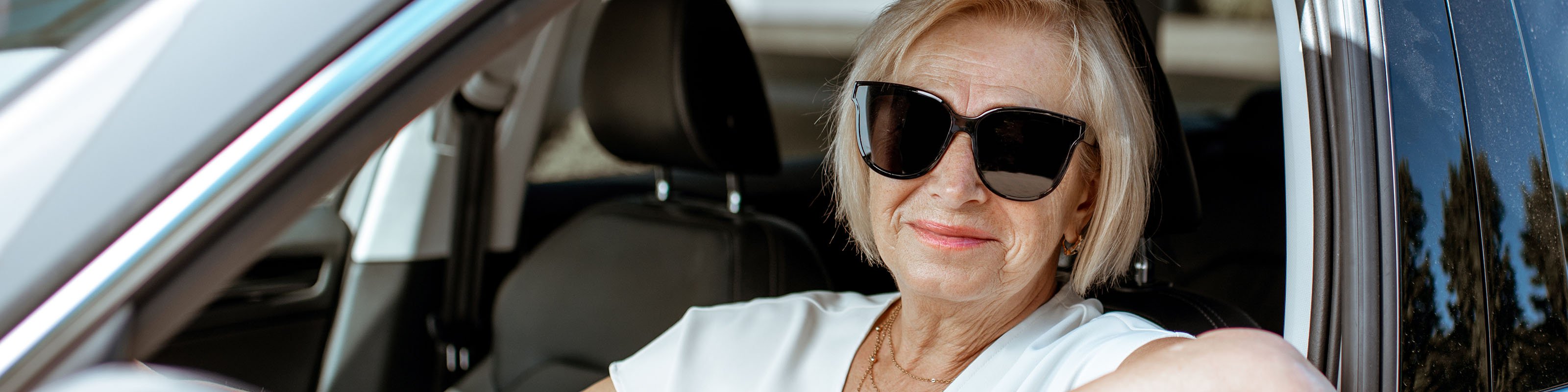 woman looking out car drivers side window