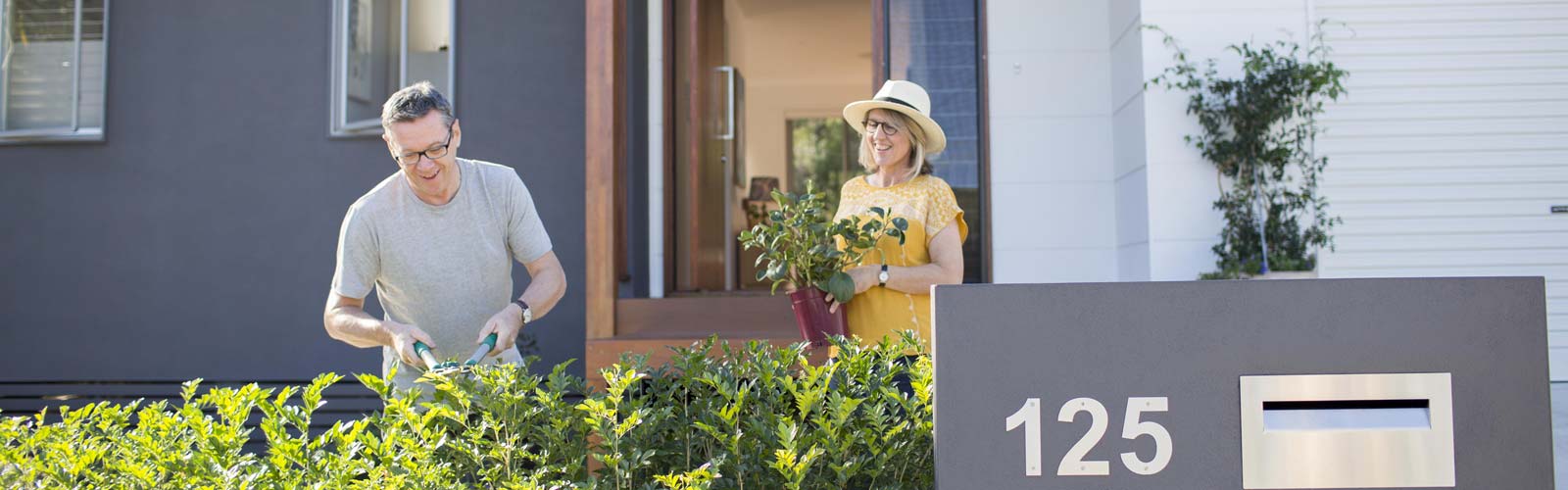 A couple gardening at frontyard.