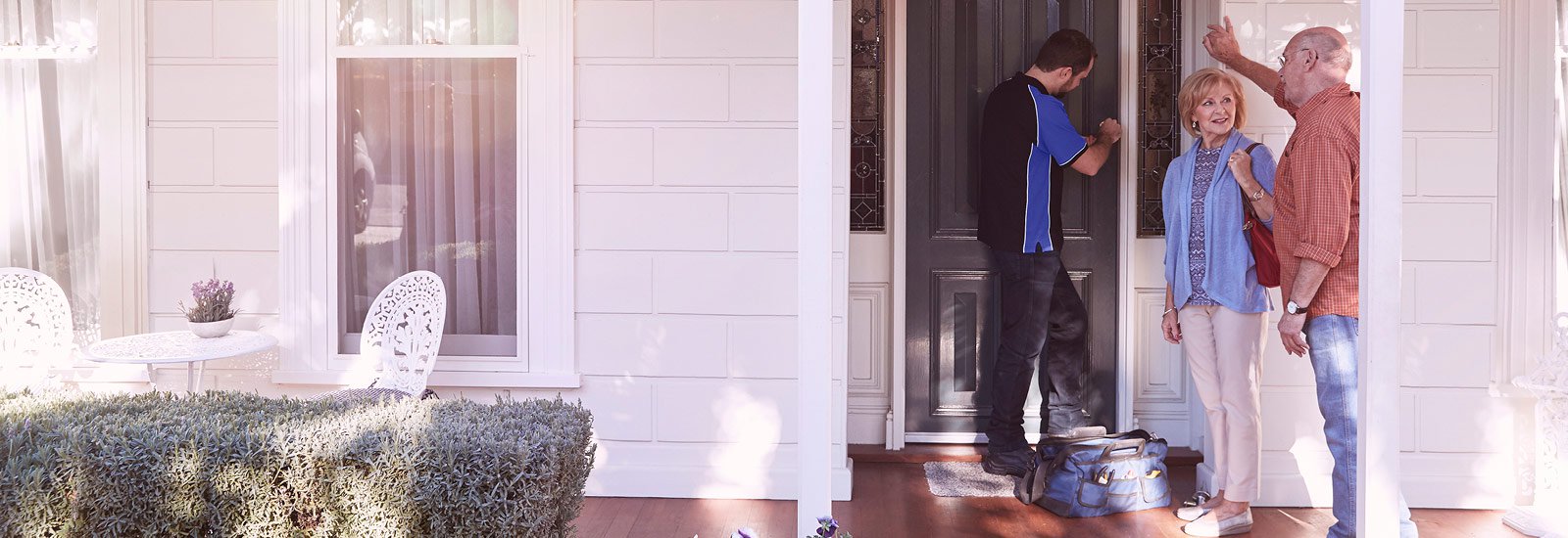 Couple with locksmith at house