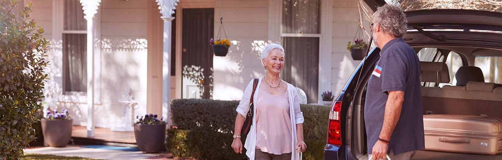 elderly couple near car
