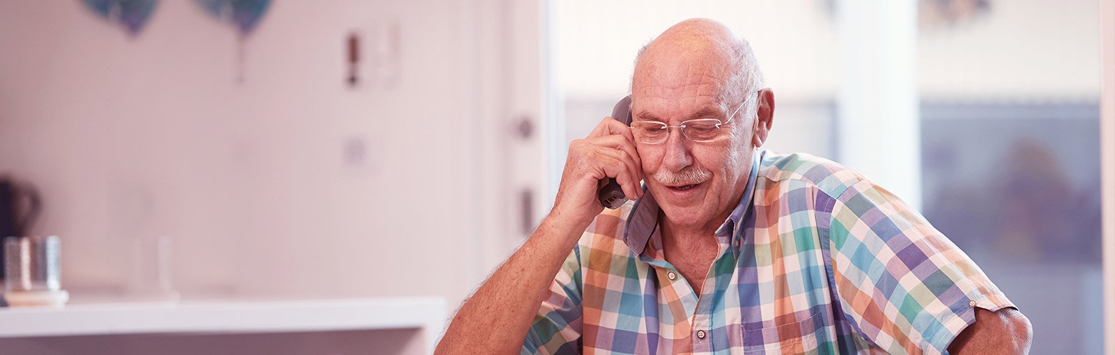 elderly man on home phone