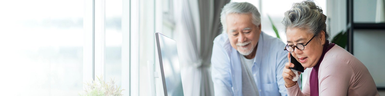 Senior couple working together at home