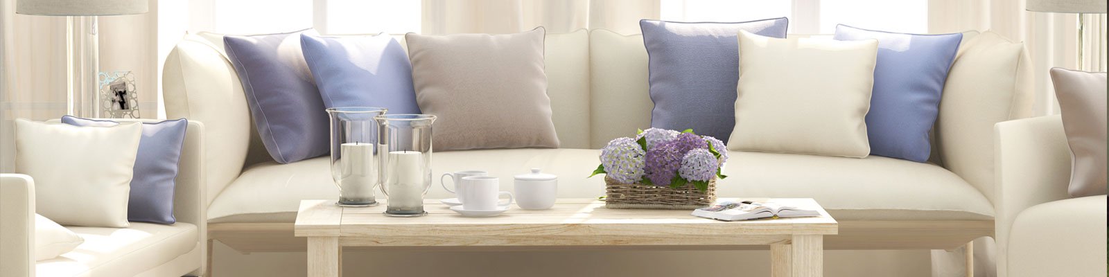 White couch and coffee table with blue cushions