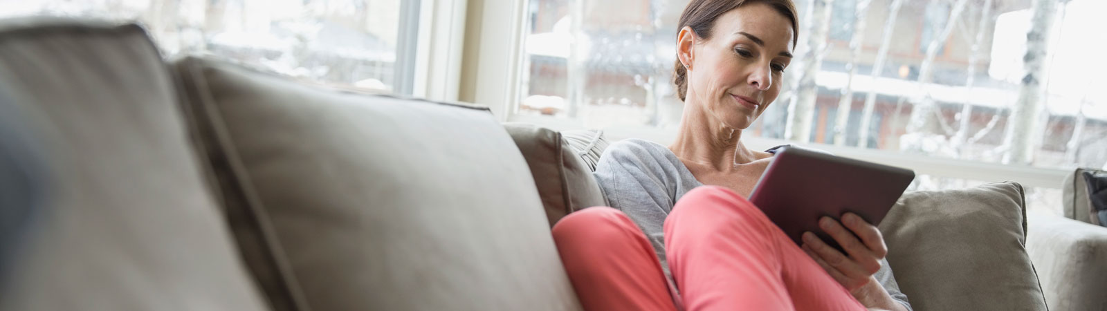 woman on couch with tablet