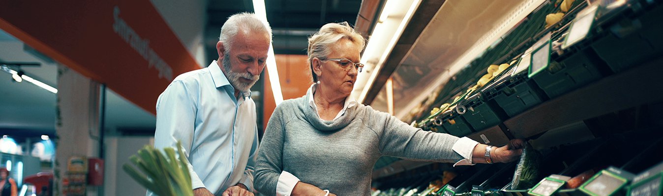 Couple selecting vegetables in a supermarket