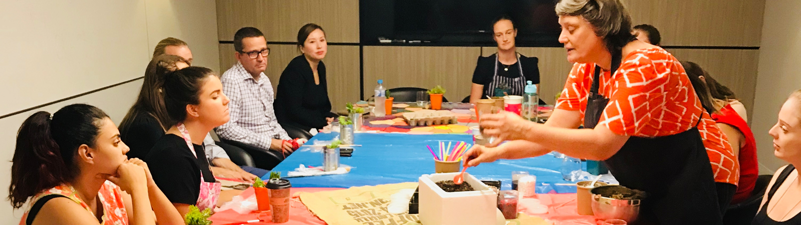 Teaching standing up at table of students in classroom