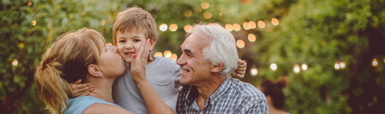 grandparents kissing grandchild