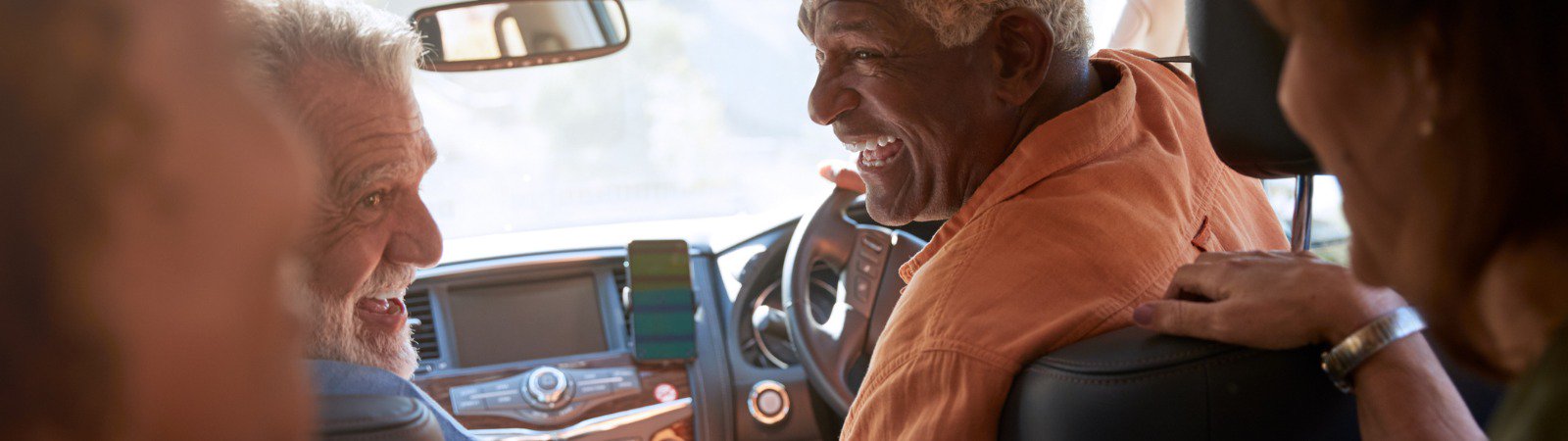 Group of smiling people in car