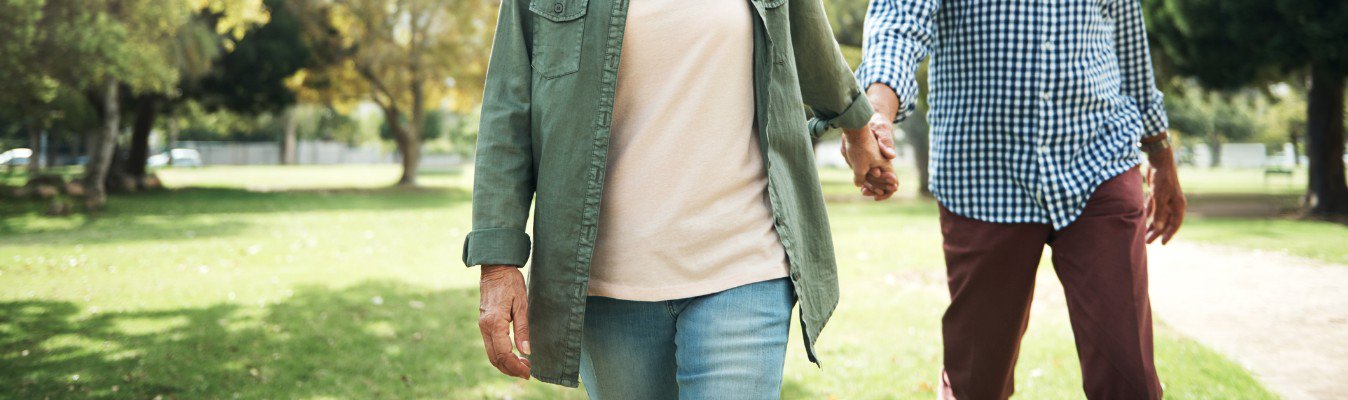 Two friends walking in park.