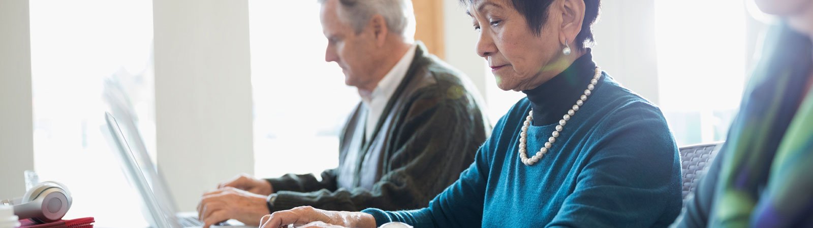 Older woman at laptop typing