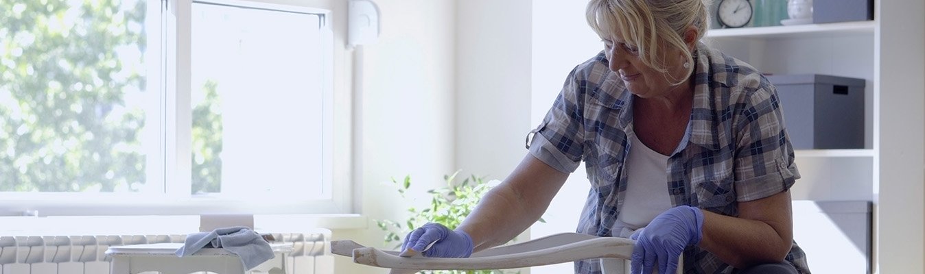 Woman sanding old furniture