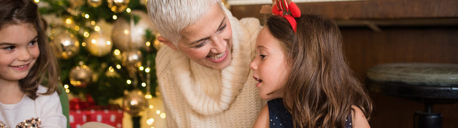 woman giving presents to children at christmas