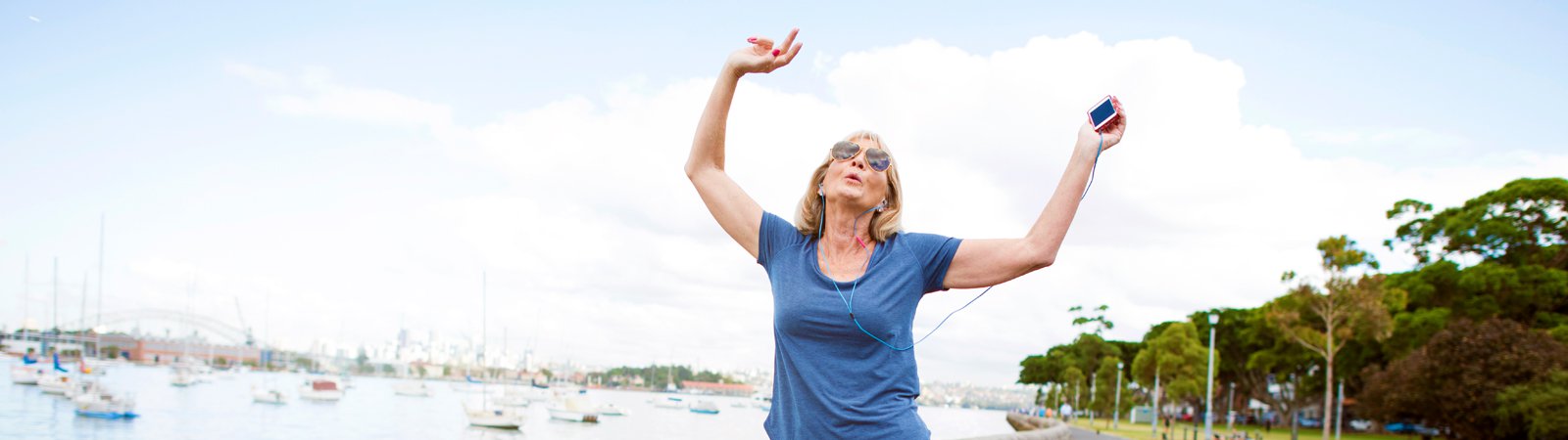 woman walking with arms raised