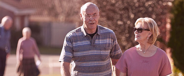 Couple walking outdoors wearing glasses